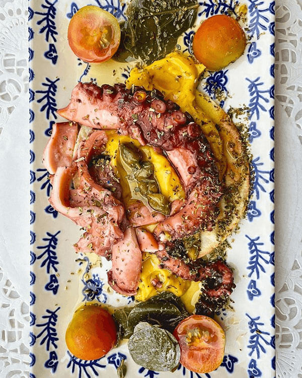 Octopus over fava bean paste with capers and cherry tomatoes.