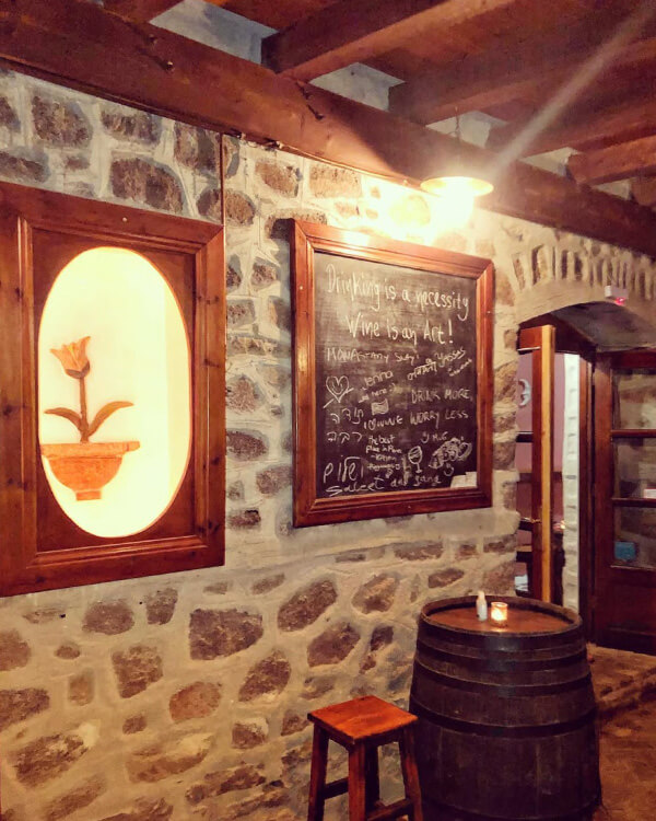An atmospheric shot of the wine bar interior, reminiscent of a wine cellar.